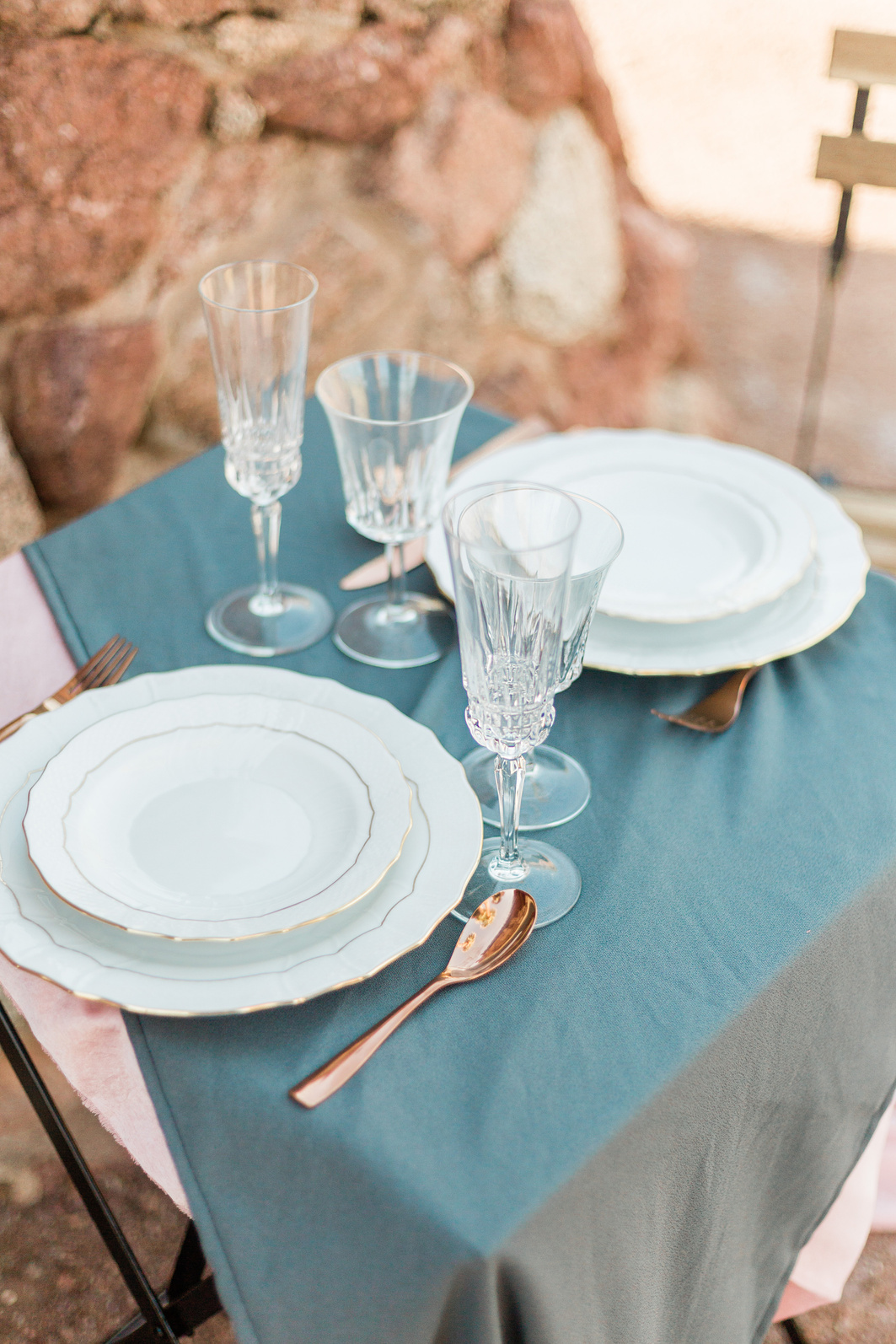 Rustic Table Setting with Dishware, Utensils and Glasses Outdoors